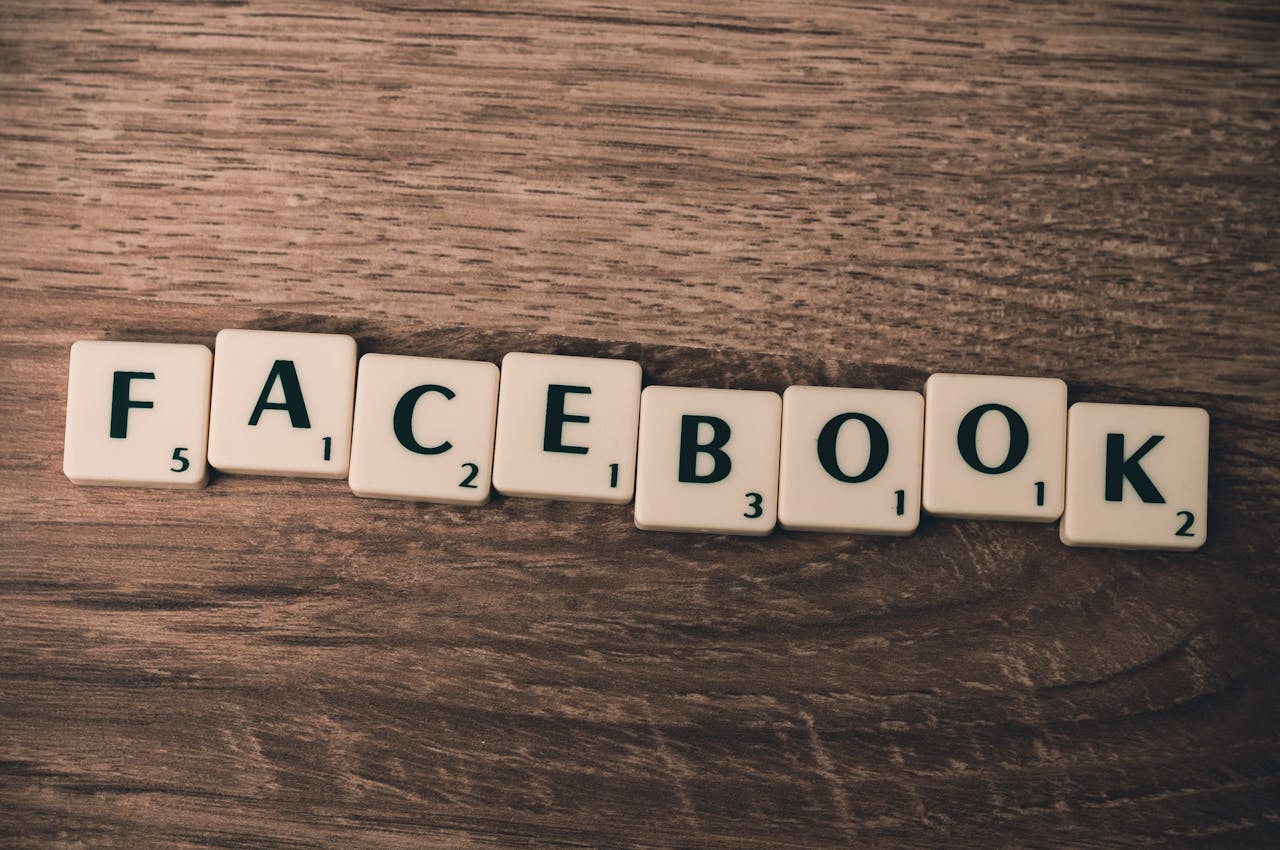cta-bg Scrabble tiles spelling Facebook on a wood background, symbolizing social media.