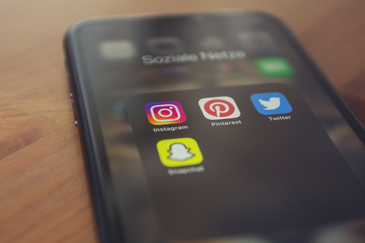 home-services-01 Smartphone displaying popular social media apps like Instagram, Pinterest, Twitter, and Snapchat.